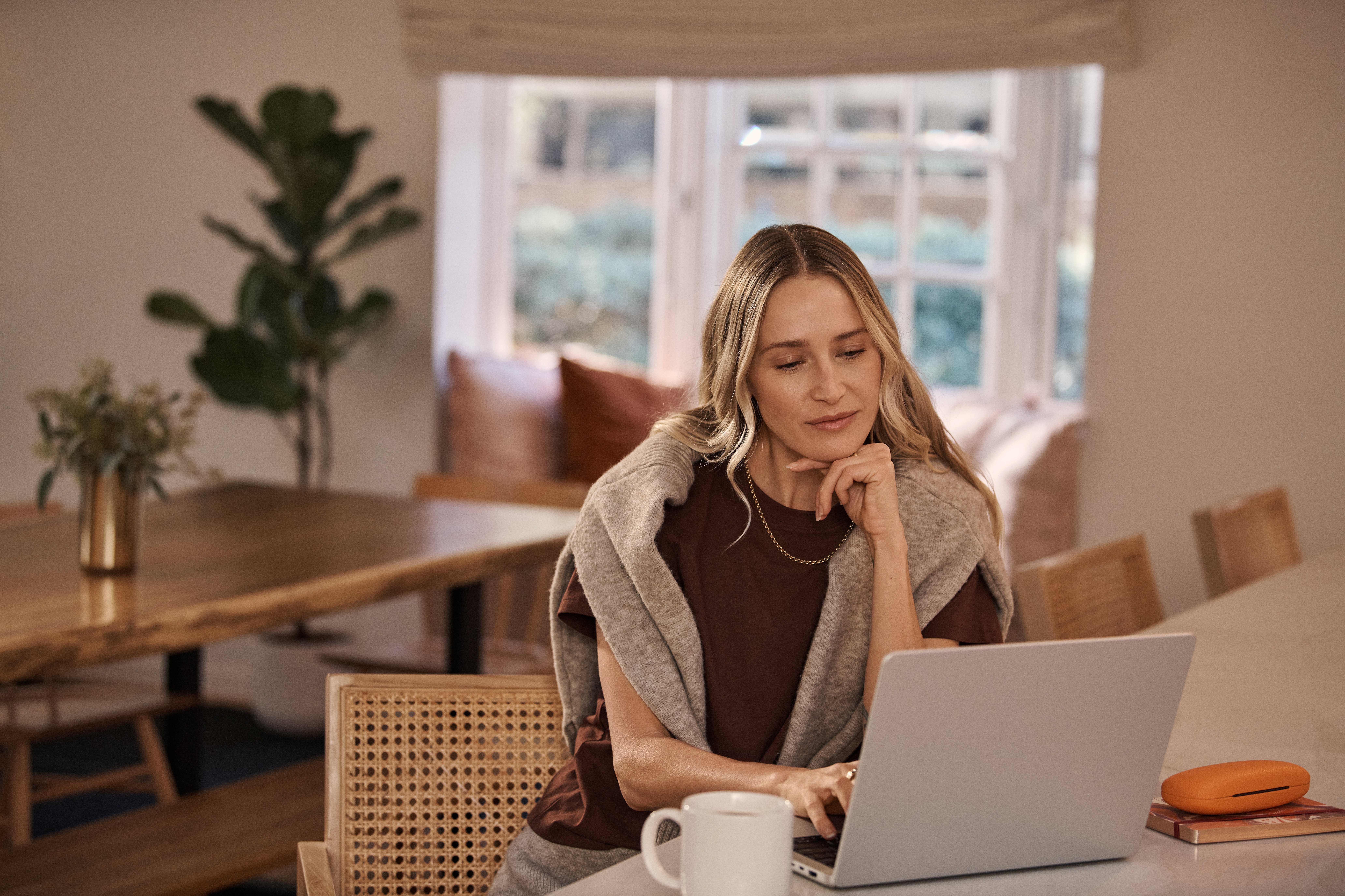 Woman at home with laptop